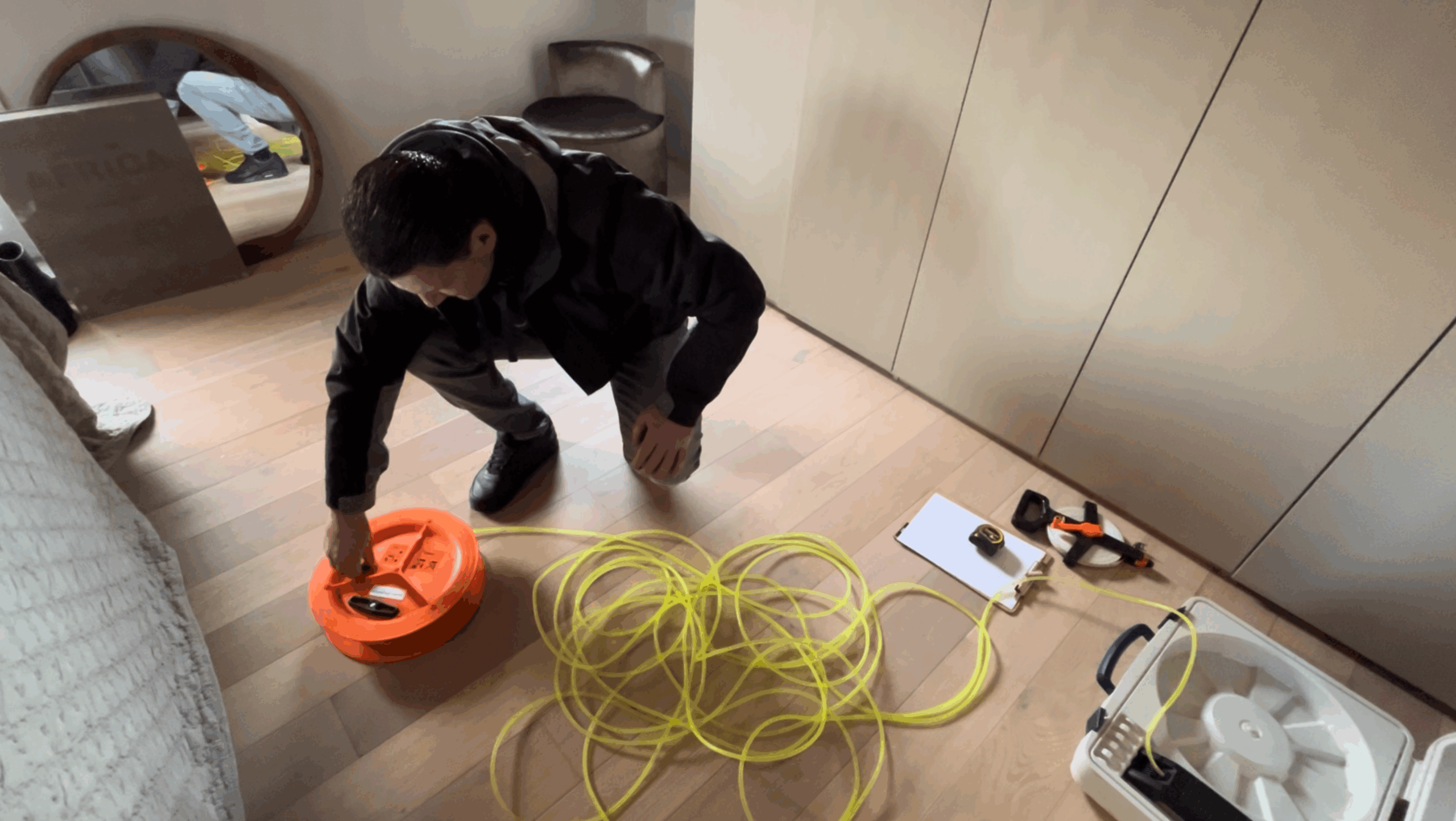 Vloerveldwaterpassing waarbij een adviseur de vloer van een woning opmeet tijdens een funderingsonderzoek fase 1